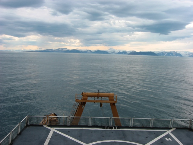 Viewing south-west towards Cape Adair, helicopter deck and aft A-frame in the foreground.