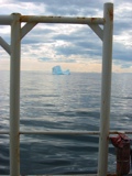 Iceberg drifting southward along Baffin Island in the background to the right.